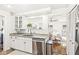 Bright kitchen with stainless steel appliances, granite counters, and an adjacent living space at 5028 Graceland Ave, Indianapolis, IN 46208