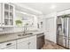 Modern kitchen with granite counters, white cabinets, stainless appliances and open layout at 5028 Graceland Ave, Indianapolis, IN 46208