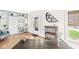 Bright living area with hardwood floors, built-in shelves, and view of the front entrance at 5028 Graceland Ave, Indianapolis, IN 46208