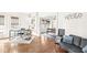Inviting living room with hardwood floors, large windows, and view into adjacent dining area at 5028 Graceland Ave, Indianapolis, IN 46208