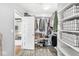 Walk-in Closet with custom shelving and storage and vinyl flooring at 5028 Graceland Ave, Indianapolis, IN 46208