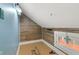 Finished attic space with natural light from window and wood wall at 5116 Norway Dr, Indianapolis, IN 46219