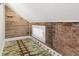 Attic space with exposed brick and unique wood plank walls at 5116 Norway Dr, Indianapolis, IN 46219