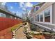 Side yard features brick path, landscaping, and a small pond at 5116 Norway Dr, Indianapolis, IN 46219