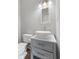 Updated bathroom with modern vessel sink and gray vanity at 5116 Norway Dr, Indianapolis, IN 46219