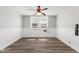 Bedroom with wood-look floors, neutral walls, and ceiling fan at 5116 Norway Dr, Indianapolis, IN 46219