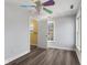 Cozy bedroom features wood-look floors, closet, and whimsical ceiling fan at 5116 Norway Dr, Indianapolis, IN 46219