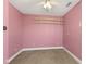 Pink bedroom with wall shelving, offering potential for customization and decor at 5116 Norway Dr, Indianapolis, IN 46219