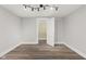 Bedroom with wood-look floors leading to closet and another room at 5116 Norway Dr, Indianapolis, IN 46219