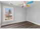 Bright bedroom with vinyl floors, neutral walls, a window, and a ceiling fan at 5116 Norway Dr, Indianapolis, IN 46219