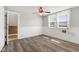 Bedroom with bright window, wood-look floors, and wall decor at 5116 Norway Dr, Indianapolis, IN 46219