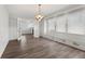 Bright dining area offering views of the living room and a charming built-in bench seat by a large window at 5116 Norway Dr, Indianapolis, IN 46219