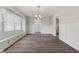 Spacious dining room featuring beadboard walls and wood-look flooring, bathed in natural light from bright windows at 5116 Norway Dr, Indianapolis, IN 46219