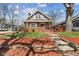 Inviting home with stone pathway, landscaped front yard and mature trees at 5116 Norway Dr, Indianapolis, IN 46219