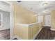 Upstairs hallway with neutral walls, wood floors, and white trim at 5116 Norway Dr, Indianapolis, IN 46219