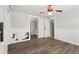 Bright living room with wood-look floors, white trim, and unique ceiling fan at 5116 Norway Dr, Indianapolis, IN 46219