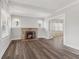 Bright living room with fireplace and wood flooring, seamlessly connects to another room through an open doorway at 5116 Norway Dr, Indianapolis, IN 46219