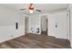 Bright living room featuring wood-look floors, white trim, and an updated ceiling fan at 5116 Norway Dr, Indianapolis, IN 46219