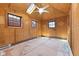 Room featuring wood paneled walls, a skylight, and tile flooring, ready for renovation at 5116 Norway Dr, Indianapolis, IN 46219