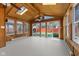 Light-filled sunroom featuring wood paneling, skylights, and windows overlooking the backyard at 5116 Norway Dr, Indianapolis, IN 46219