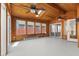 Spacious sunroom featuring wood paneling, multiple windows, skylights, and a sliding glass door to the exterior at 5116 Norway Dr, Indianapolis, IN 46219