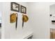 Charming entryway features built-in bench, coat hooks with hats and umbrellas, and artwork at 5332 W Glenview Dr, McCordsville, IN 46055