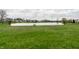 Expansive grassy backyard leading to a serene lake view, perfect for outdoor activities and relaxation at 5367 Cotton Bay W Dr, Indianapolis, IN 46254