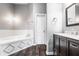 Beautiful bathroom featuring a jetted tub, updated vanity, and wood-look flooring at 5367 Cotton Bay W Dr, Indianapolis, IN 46254
