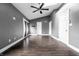 Spacious bedroom featuring dark wood flooring, a ceiling fan, and access to the outdoors at 5367 Cotton Bay W Dr, Indianapolis, IN 46254