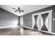 Bedroom featuring hardwood floors, neutral paint, a ceiling fan, and a door to the outdoor balcony at 5367 Cotton Bay W Dr, Indianapolis, IN 46254