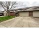 Spacious townhome exterior featuring attached garages and a wide driveway for easy parking at 5367 Cotton Bay W Dr, Indianapolis, IN 46254