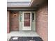 Close-up of a home's exterior featuring a brick facade and front door with sidelights at 5367 Cotton Bay W Dr, Indianapolis, IN 46254