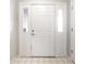 Bright entryway featuring a white front door with sidelights and tiled flooring at 5367 Cotton Bay W Dr, Indianapolis, IN 46254