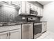 Kitchen featuring stainless steel appliances and dark backsplash at 5367 Cotton Bay W Dr, Indianapolis, IN 46254