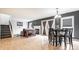 Open-concept living room with hardwood floors, fireplace, and dining area at 5367 Cotton Bay W Dr, Indianapolis, IN 46254