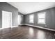 Bright, empty living room with gray walls, white trim, and hardwood floors, ready for its new owners at 5367 Cotton Bay W Dr, Indianapolis, IN 46254