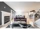 Inviting living room featuring a fireplace, sofa, and view into the kitchen at 5367 Cotton Bay W Dr, Indianapolis, IN 46254