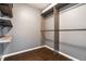 Functional walk-in closet with built-in wood shelving and hanging rods for optimal organization at 5367 Cotton Bay W Dr, Indianapolis, IN 46254