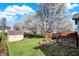 Inviting backyard with a deck, shed and blooming trees creating a serene outdoor space at 5426 Black Bear Cir, Indianapolis, IN 46239