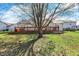 Private backyard view with lush green lawn, patio area, and mature trees for shade and privacy at 5426 Black Bear Cir, Indianapolis, IN 46239