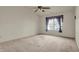 This spacious bedroom features a large window with ceiling fan and neutral carpeting at 5426 Black Bear Cir, Indianapolis, IN 46239