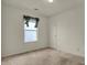 Simple carpeted bedroom featuring a window with blinds and valance with a door to the hall at 5426 Black Bear Cir, Indianapolis, IN 46239
