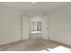 Spacious bedroom with neutral carpet and open doorway leading to other rooms at 5426 Black Bear Cir, Indianapolis, IN 46239