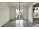 Minimalist dining area featuring modern chandelier and sliding glass doors leading to a patio at 5426 Black Bear Cir, Indianapolis, IN 46239