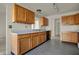 Practical kitchen featuring wood cabinets with laminate countertops and stainless steel sink at 5426 Black Bear Cir, Indianapolis, IN 46239