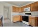 Efficient kitchen with wooden cabinets and white appliances at 5426 Black Bear Cir, Indianapolis, IN 46239