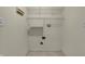 A laundry room with utility hookups, wire shelving, and tile floors ready for a new washer and dryer at 5426 Black Bear Cir, Indianapolis, IN 46239