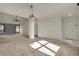 Open-concept living room with neutral carpet, stylish lighting, and view to the kitchen at 5426 Black Bear Cir, Indianapolis, IN 46239