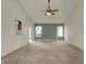 Open-concept living room with a vaulted ceiling, neutral tones, and natural light at 5426 Black Bear Cir, Indianapolis, IN 46239