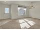 Inviting room featuring a window, neutral carpet, and stylish light fixture at 5426 Black Bear Cir, Indianapolis, IN 46239